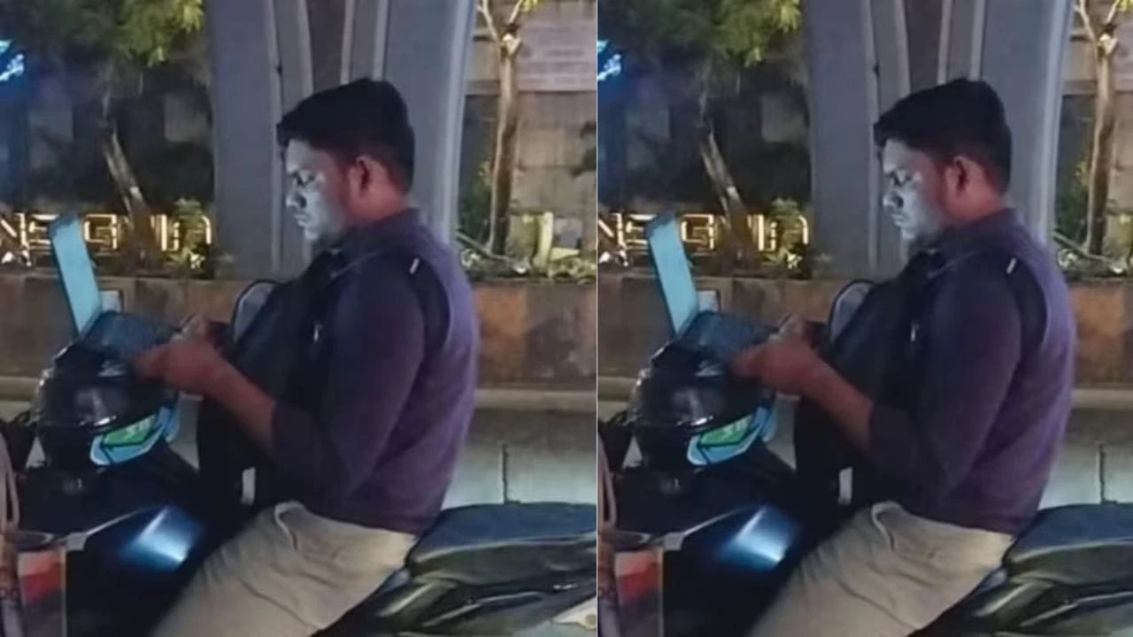 सड़क पर बाइक और हाथ में लैपटॉप कॉर्पोरेट वर्क कल्चर की ये तस्वीर आपको डरा देगी