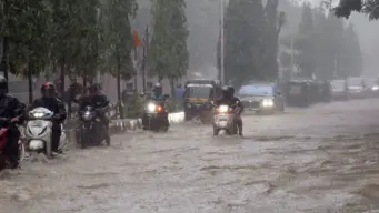 Mumbai Rains Trigger Flight Delays, Flood Roads, Disrupt Daily Life; IMD Retains Red Alert