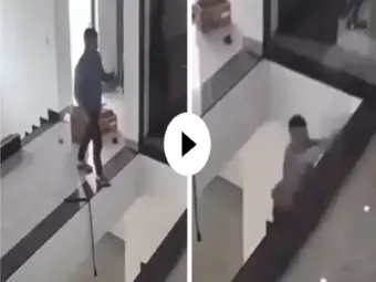 Video: Young man busy using his mobile phone falls straight down from the first floor; shocking video goes viral