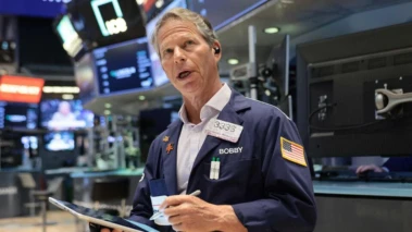Wall Street edges lower as crude oil rises on reports that Iran will retain enriched uranium