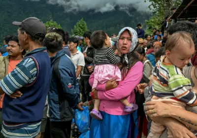 Five-year-old survivor waits alone after devastating Nepal floods