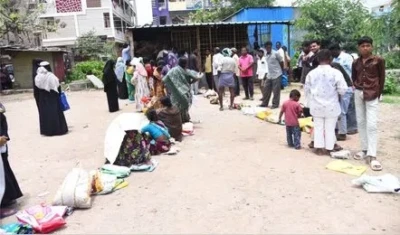 రేషన్ షాపుల వద్ద బారులు.. ఎండలోనే బియ్యం కోసం పడిగాపులు