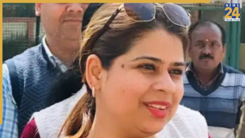 Who is DM Jasjit Kaur, against whom a warrant has been issued? What rank did she secure to become an IAS officer?